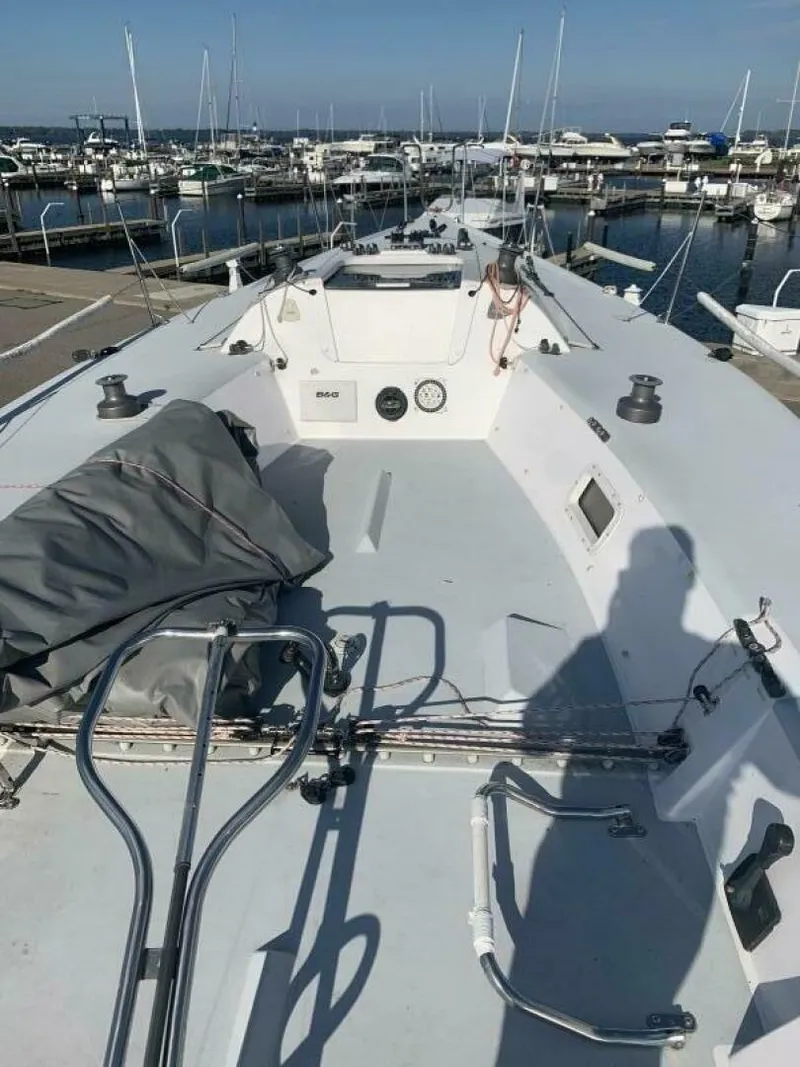 Slide: The Image of 1996 Farr 30 sailboat docked at a marina, showcasing deck and equipment. - 7