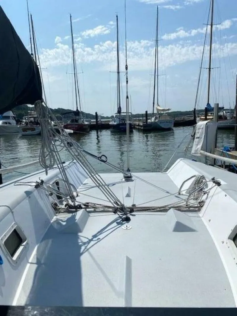 Slide: The Image of Sailboat deck view at marina, Farr 30, 1996 model, with rigging and masts visible. - 8