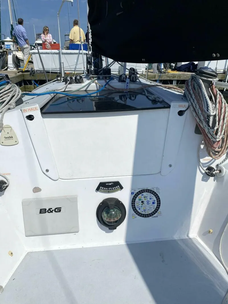 Slide: The Image of 1996 Farr 30 sailboat cockpit with navigation instruments and coiled ropes. - 9