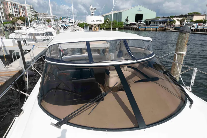 Slide: The Image of 2003 Viking Princess V50 Express yacht docked at marina, featuring Garmin navigation system. - 15