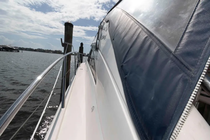 Slide: The Image of 2003 Viking Princess V50 Express yacht docked by the water on a sunny day. - 17