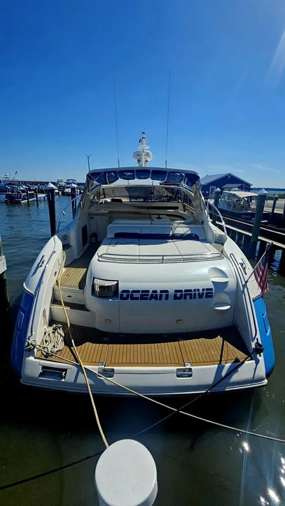 Slide: The Image of 2003 Viking Princess V50 Express yacht docked at marina under clear blue sky. - 2