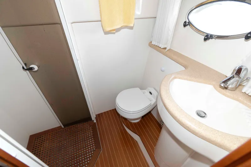 Slide: The Image of Bathroom interior of 2003 Viking Princess V50 Express yacht, featuring sink, toilet, and shower. - 24