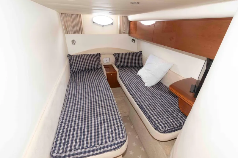 Slide: The Image of 2003 Viking Princess V50 Express cabin with twin beds and checkered bedding. - 25