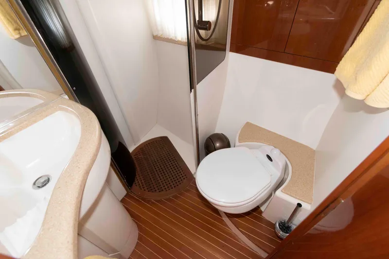 Slide: The Image of Luxurious bathroom in 2003 Viking Princess V50 Express yacht with modern fixtures and wood flooring. - 26