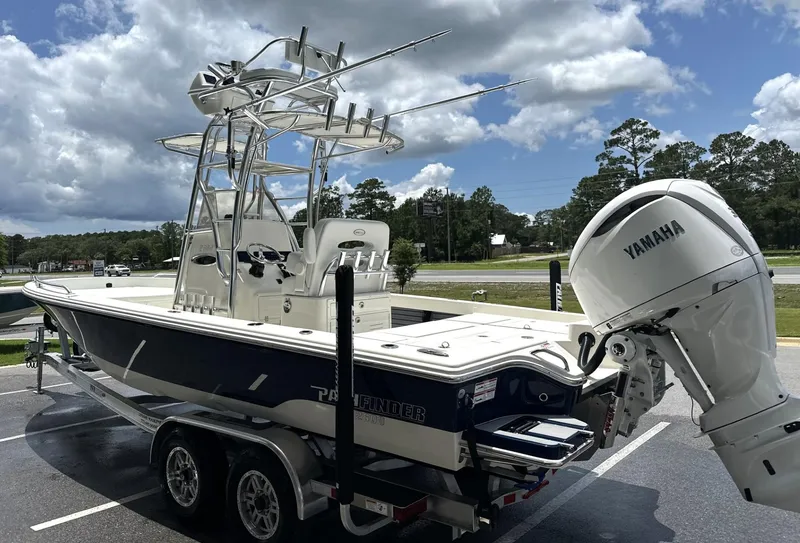 Slide: The Image of 2025 Pathfinder 2600 TRS boat with Yamaha engine on trailer, parked outdoors. - 12