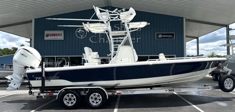 Slide: The Image of 2025 Pathfinder 2600 TRS boat on trailer, displayed outside dealership. - 16
