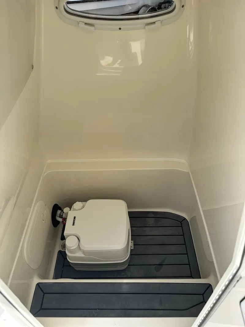 Slide: The Image of 2025 Pathfinder 2600 TRS boat interior with compact marine toilet. - 19