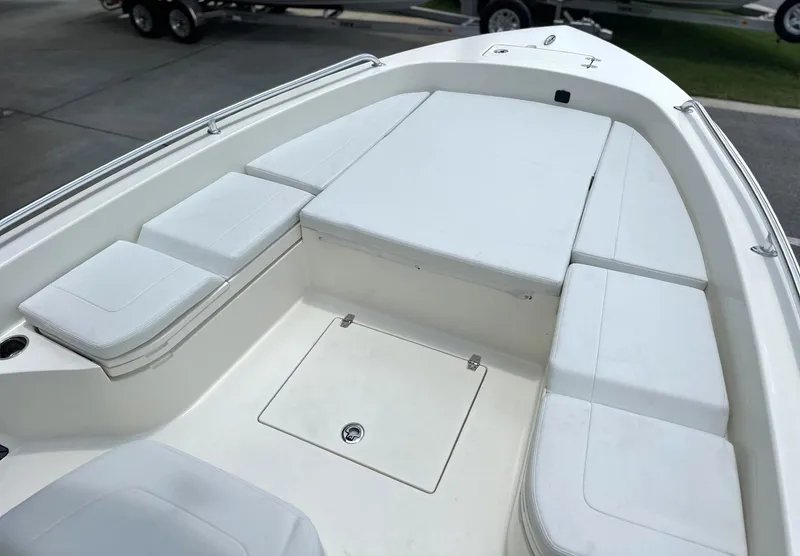 Slide: The Image of 2025 Pathfinder 2600 TRS boat interior with cushioned seating and storage compartments. - 2