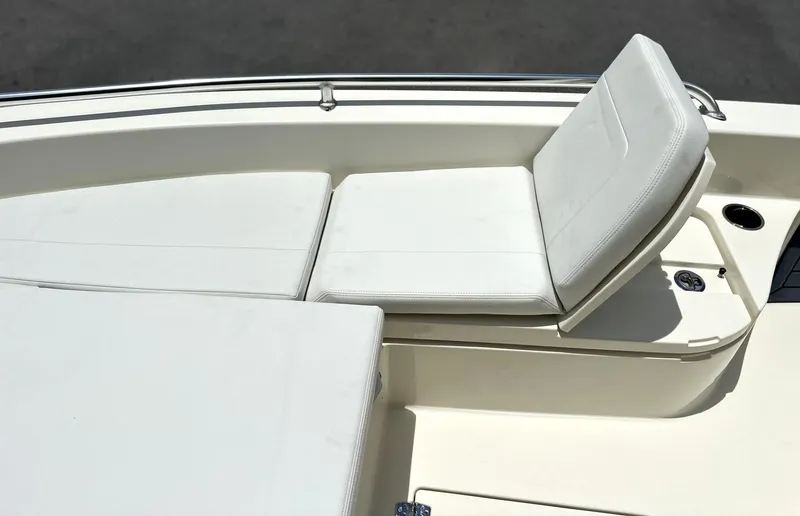Slide: The Image of 2025 Pathfinder 2600 TRS boat with white cushioned seating and cup holder. - 21