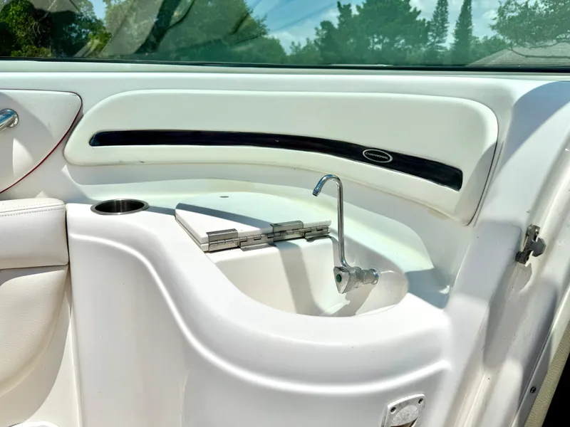 Slide: The Image of 2003 Chaparral 225 SSi boat interior with sink and cup holder. - 12