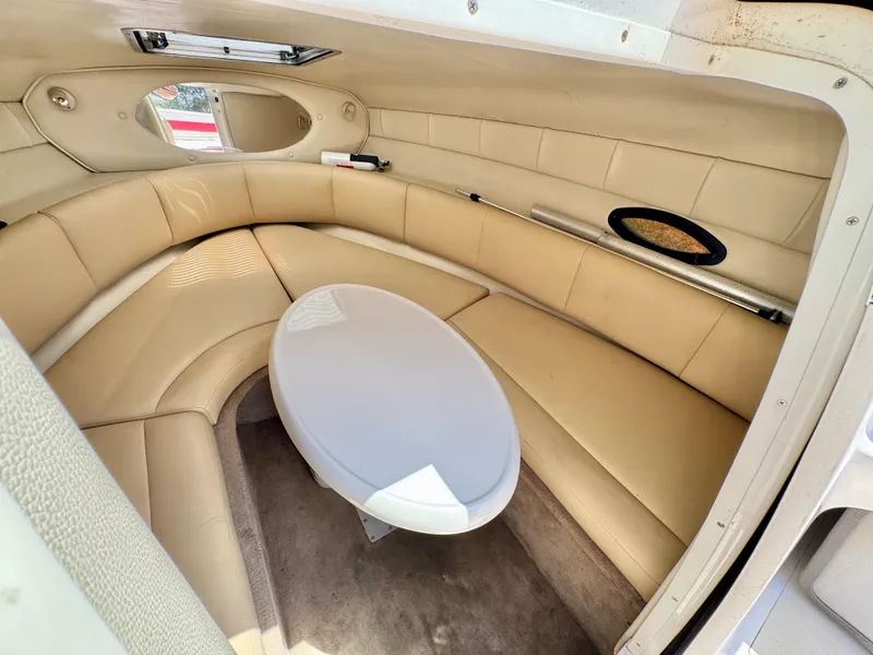 Slide: The Image of Interior of 2003 Chaparral 225 SSi boat with beige seating and oval table. - 13