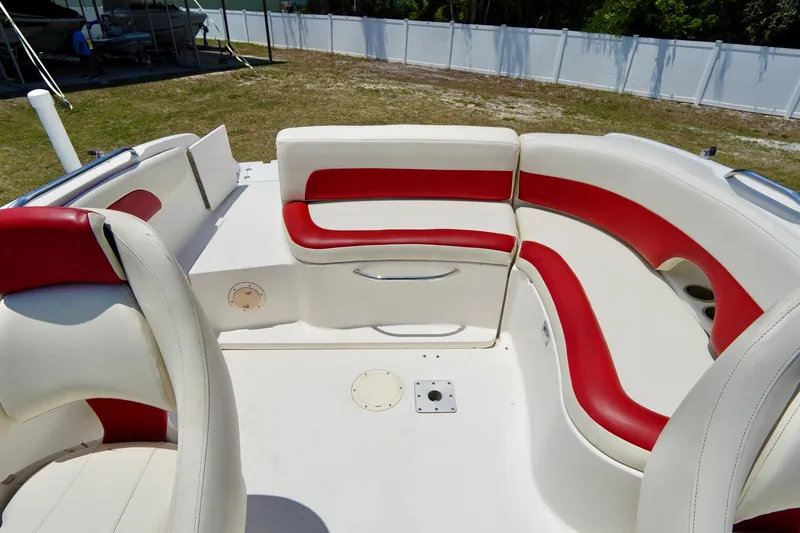 Slide: The Image of 2003 Chaparral 225 SSi boat interior with red and white seating, outdoor setting. - 16