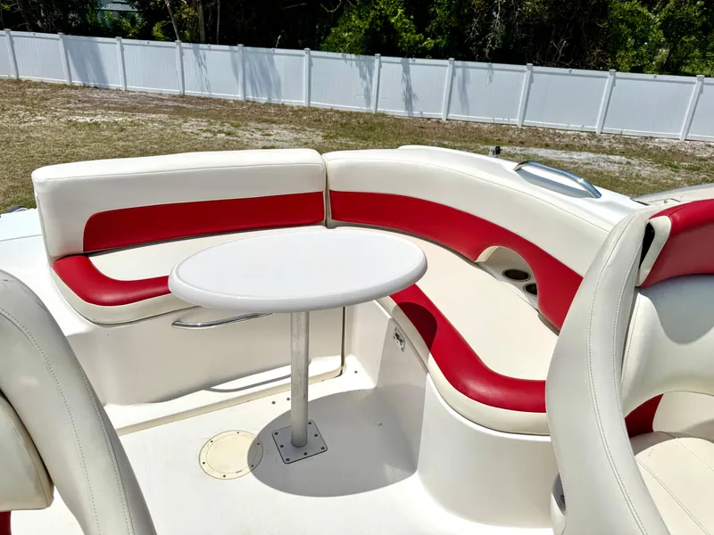 Slide: The Image of 2003 Chaparral 225 SSi boat interior with red and white seating and a round table. - 17