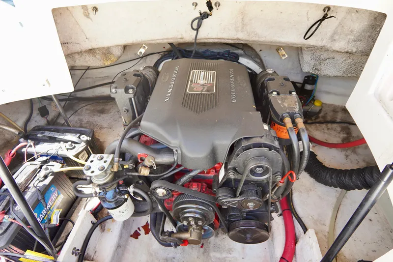 Slide: The Image of Engine compartment of a 2003 Chaparral 225 SSi boat, featuring a powerful motor setup. - 19
