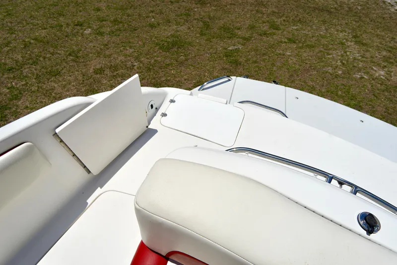 Slide: The Image of 2003 Chaparral 225 SSi boat interior with white and red seating, open storage compartment. - 21