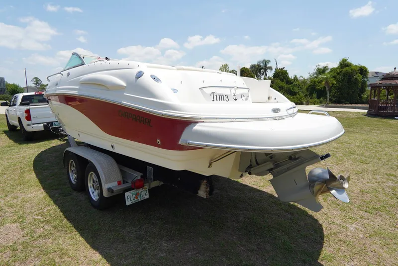 Slide: The Image of 2003 Chaparral 225 SSi boat on trailer, parked on grass under a clear sky. - 24