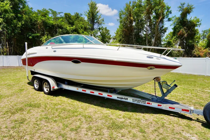 Slide: The Image of 2003 Chaparral 225 SSi boat on trailer, parked on grass with trees in background. - 4