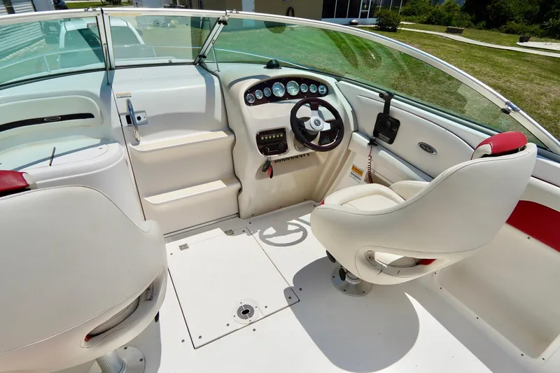 Slide: The Image of Interior of 2003 Chaparral 225 SSi boat with white seating and dashboard. - 7
