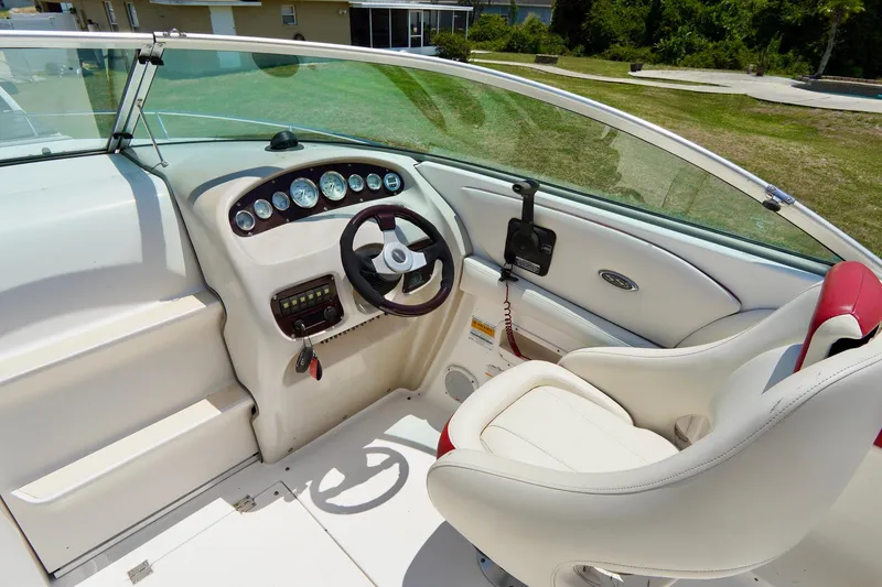 Slide: The Image of 2003 Chaparral 225 SSi boat cockpit with steering wheel and gauges. - 9