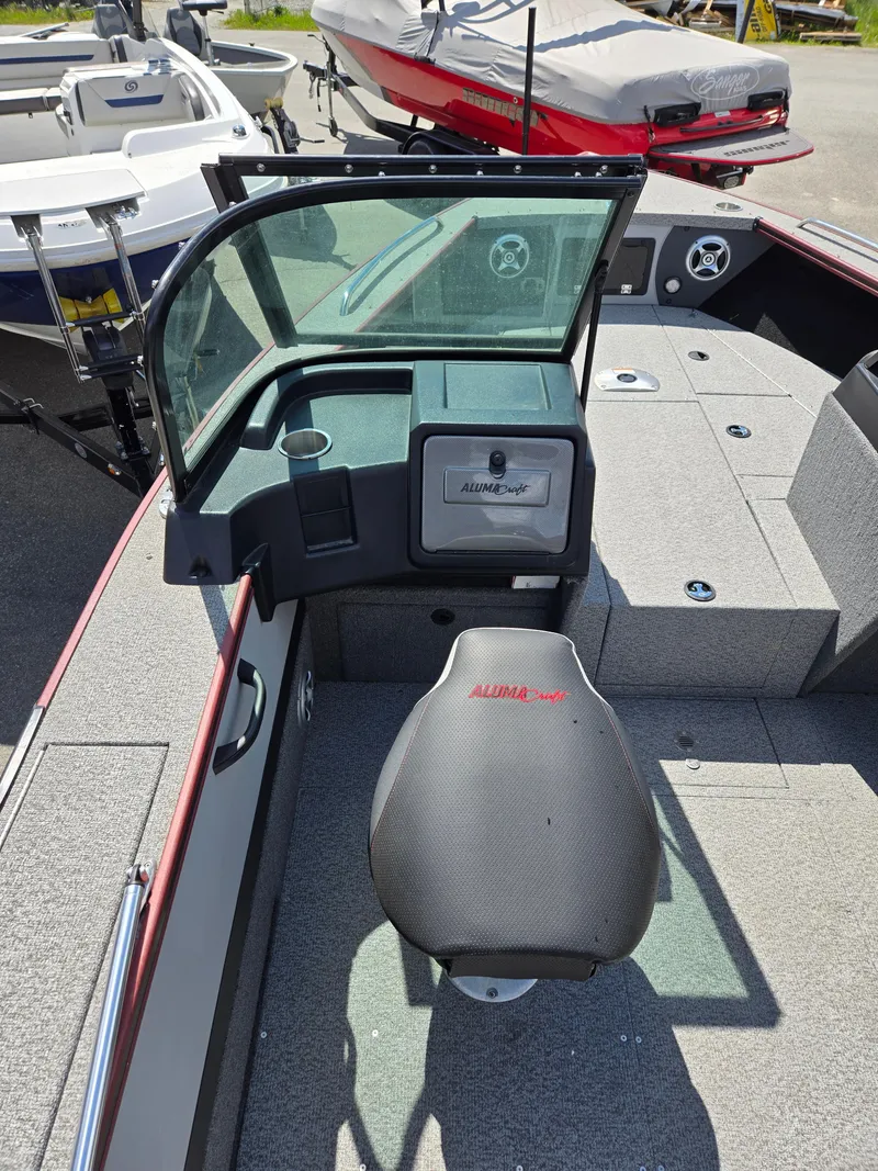 Slide: The Image of 2022 Alumacraft Trophy 185 boat interior with seating and dashboard. - 10