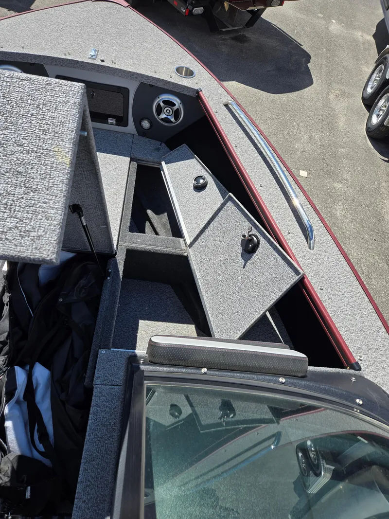 Slide: The Image of 2022 Alumacraft Trophy 185 boat interior with open storage compartments. - 7