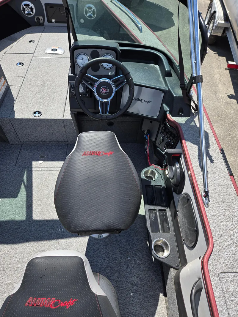 Slide: The Image of 2022 Alumacraft Trophy 185 boat interior with steering wheel and seating. - 9