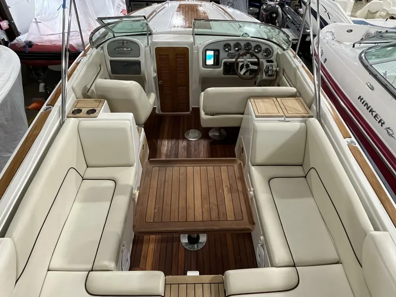 Slide: The Image of 2005 Chris-Craft Corsair 28 boat interior with wooden deck and cream seating. - 11