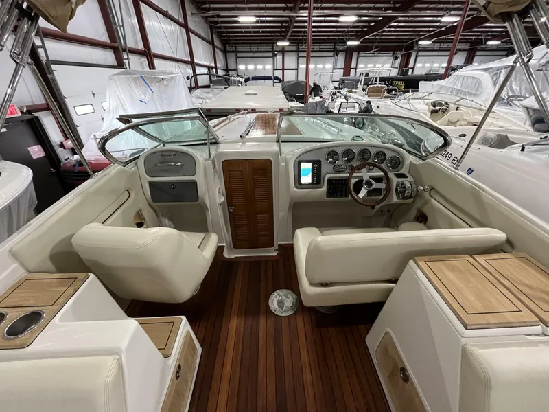 Slide: The Image of 2005 Chris-Craft Corsair 28 boat interior with wooden flooring and leather seating. - 13