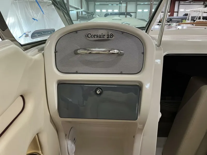 Slide: The Image of 2005 Chris-Craft Corsair 28 boat interior dashboard with storage compartment. - 20
