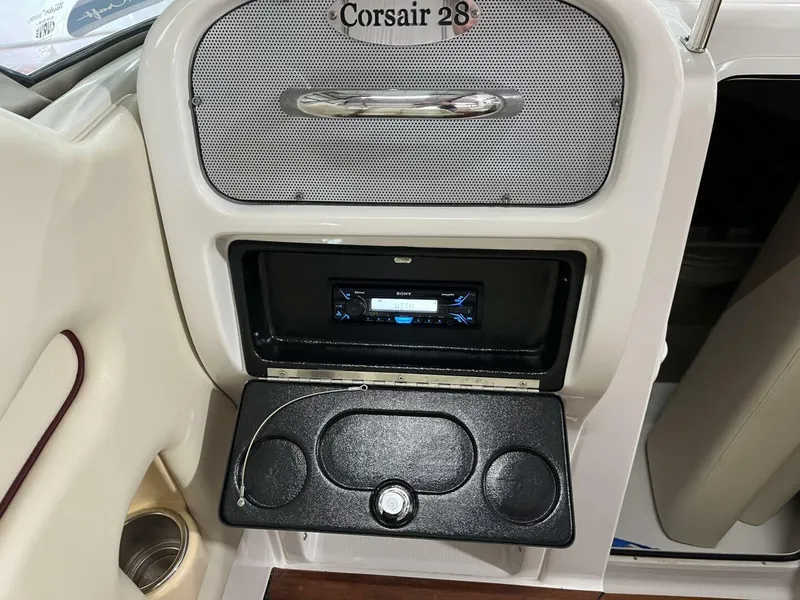 Slide: The Image of 2005 Chris-Craft Corsair 28 dashboard with audio system and cup holders. - 21
