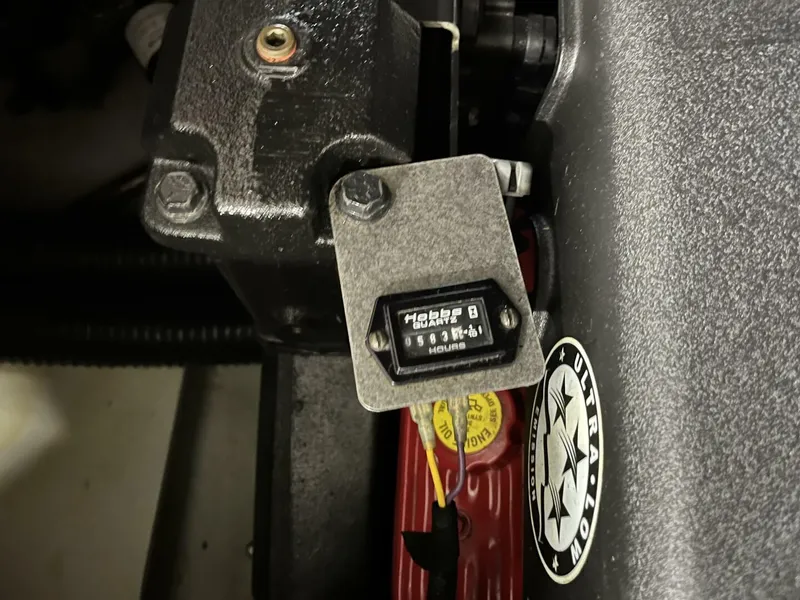 Slide: The Image of Engine component of a 2005 Chris-Craft Corsair 28 boat, featuring a Hobbs hour meter. - 28