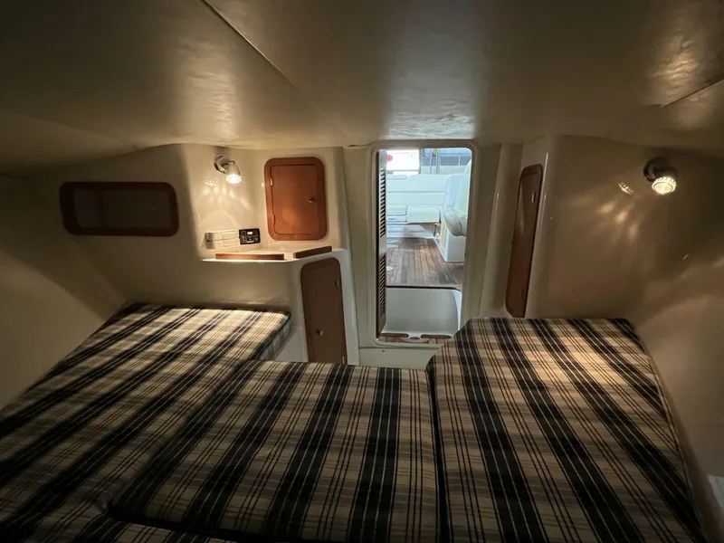 Slide: The Image of 2005 Chris-Craft Corsair 28 cabin interior with twin beds and ambient lighting. - 35
