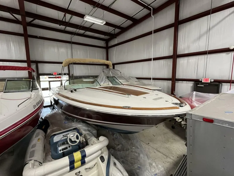 Slide: The Image of 2005 Chris-Craft Corsair 28 boat in storage, featuring classic design and elegant detailing. - 4