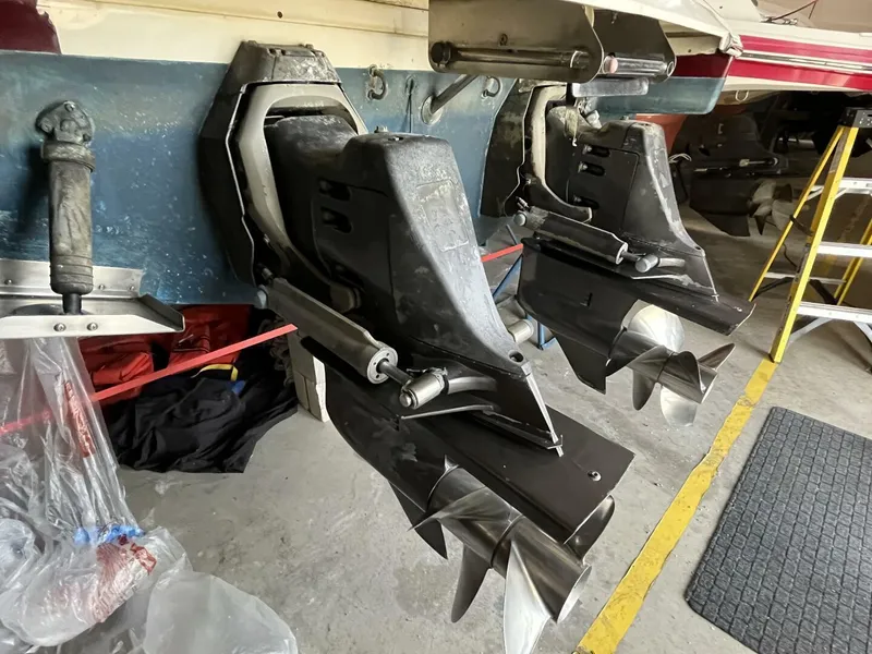 Slide: The Image of 2005 Chris-Craft Corsair 28 boat with dual propeller drives in a garage setting. - 40