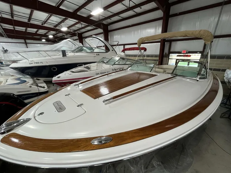 Slide: The Image of 2005 Chris-Craft Corsair 28 boat with wooden deck, stored indoors. - 6