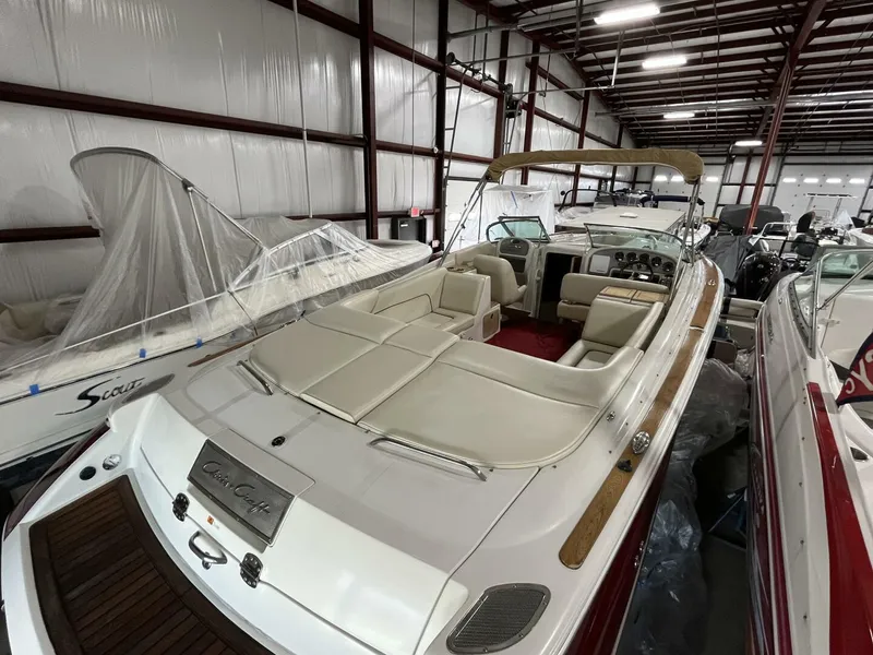 Slide: The Image of 2005 Chris-Craft Corsair 28 boat in storage, showcasing elegant design and spacious seating. - 8
