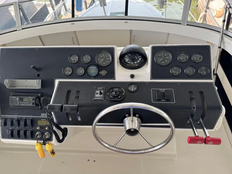 Slide: The Image of 1994 Carver 350 Aft Cabin helm with steering wheel and control panel. - 14