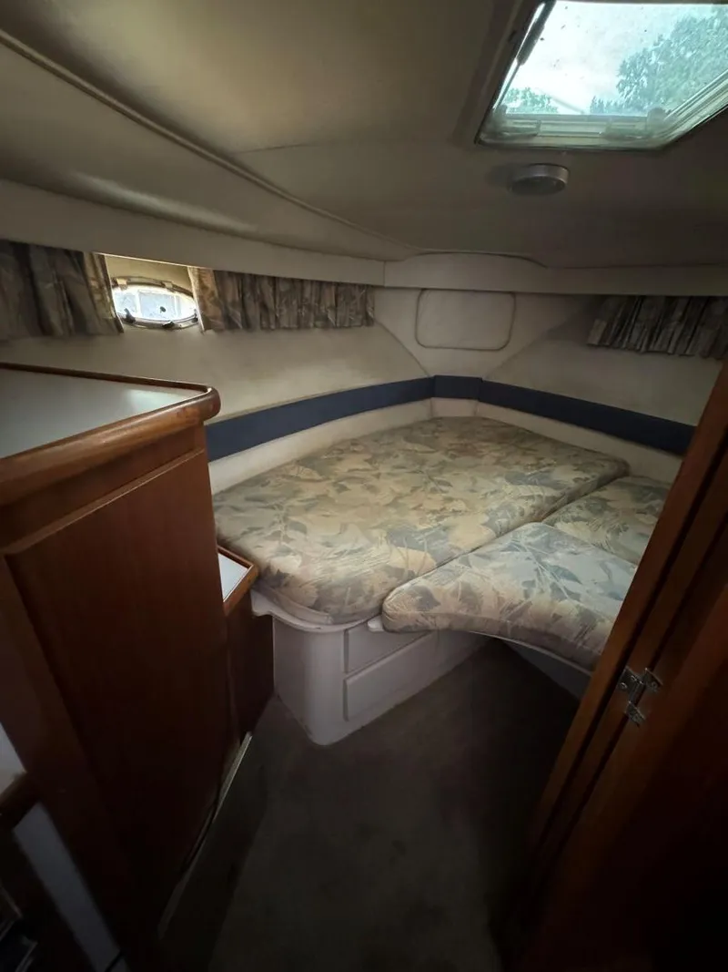 Slide: The Image of 1994 Carver 350 Aft Cabin interior with cozy bed and wooden cabinetry. - 25