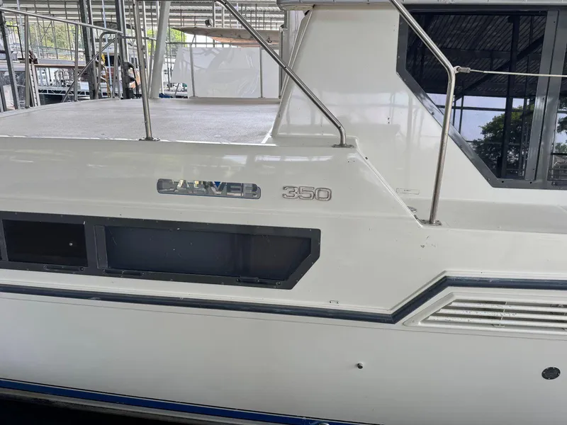 Slide: The Image of 1994 Carver 350 Aft Cabin yacht side view in a marina setting. - 3