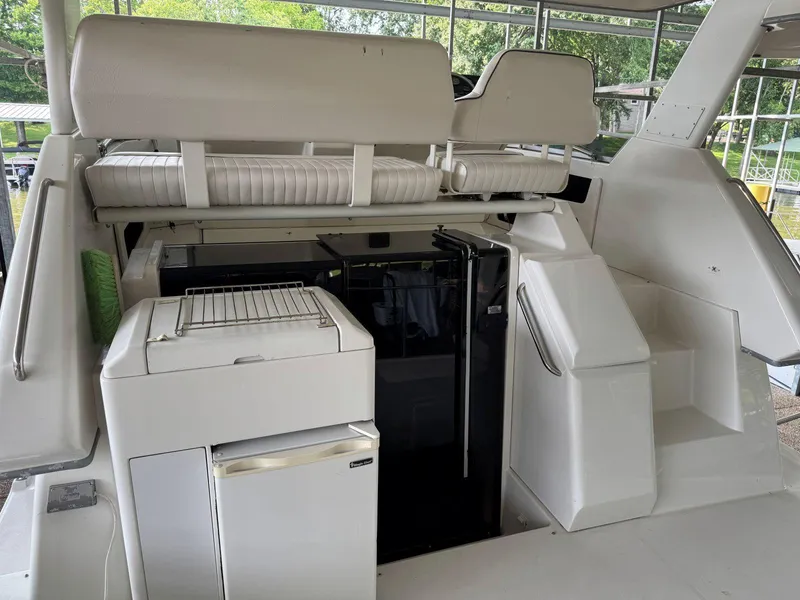 Slide: The Image of 1994 Carver 350 Aft Cabin yacht interior with seating and kitchenette area. - 8