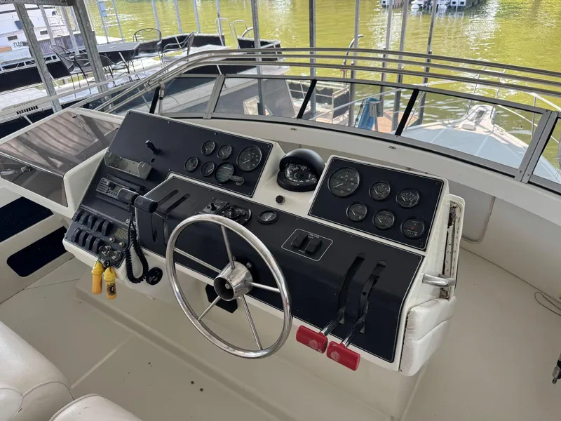 Slide: The Image of 1994 Carver 350 Aft Cabin helm with steering wheel and instrument panel. - 10