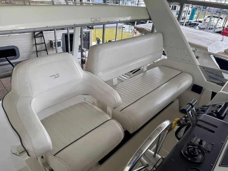 Slide: The Image of 1994 Carver 350 Aft Cabin interior with white seating and helm controls. - 11