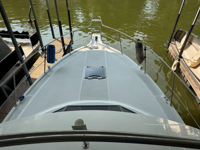 Slide: The Image of 1994 Carver 350 Aft Cabin boat docked on calm water, viewed from above. - 13