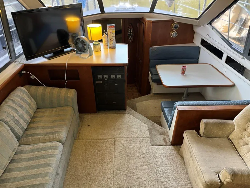 Slide: The Image of Interior of 1994 Carver 350 Aft Cabin with seating, table, and TV. - 17