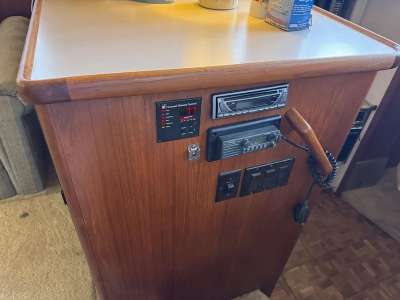 Slide: The Image of 1994 Carver 350 Aft Cabin interior control panel with radio and temperature display. - 21