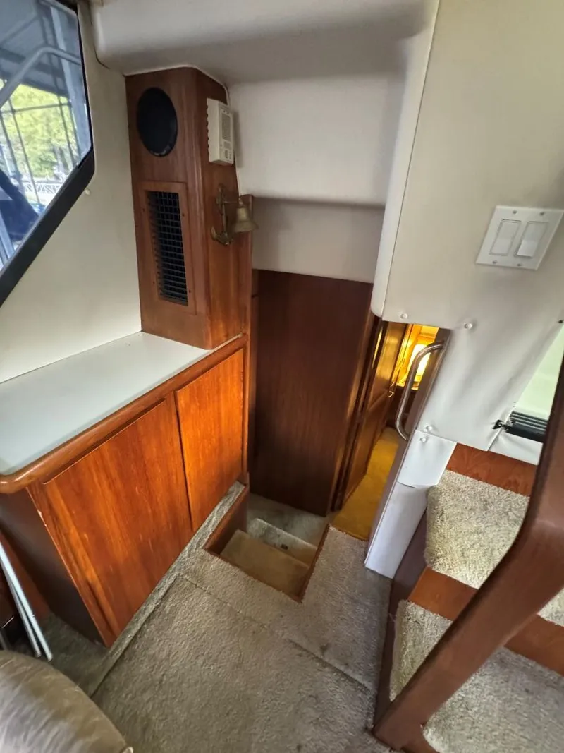 Slide: The Image of 1994 Carver 350 Aft Cabin interior with wooden cabinetry and carpeted stairs. - 26