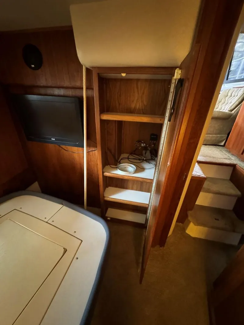 Slide: The Image of Interior of 1994 Carver 350 Aft Cabin with shelves and TV. - 31
