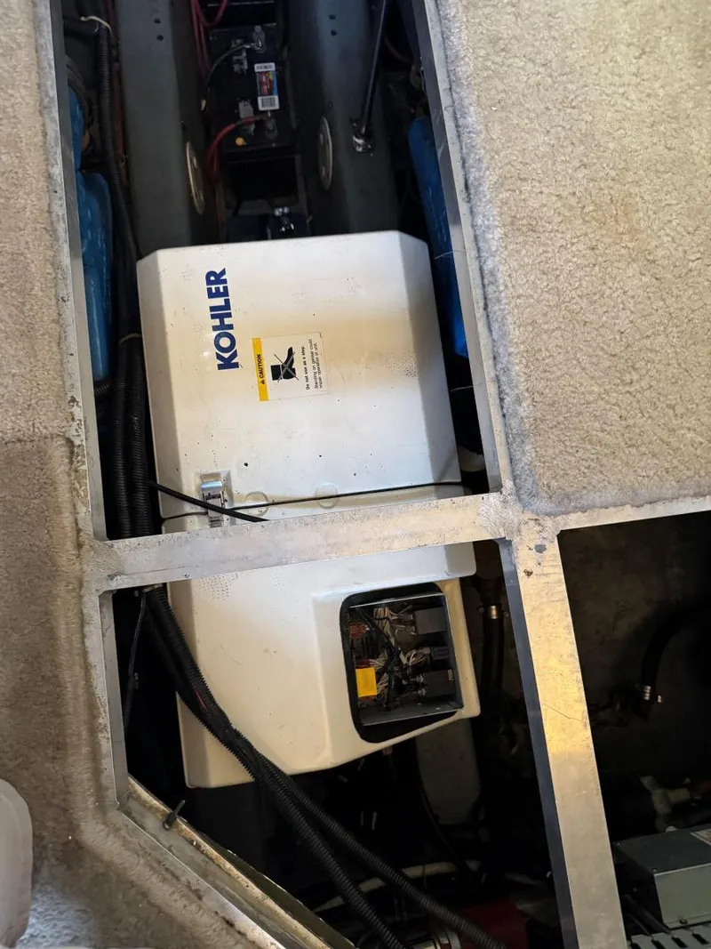 Slide: The Image of 1994 Carver 350 Aft Cabin engine room with Kohler generator visible. - 33