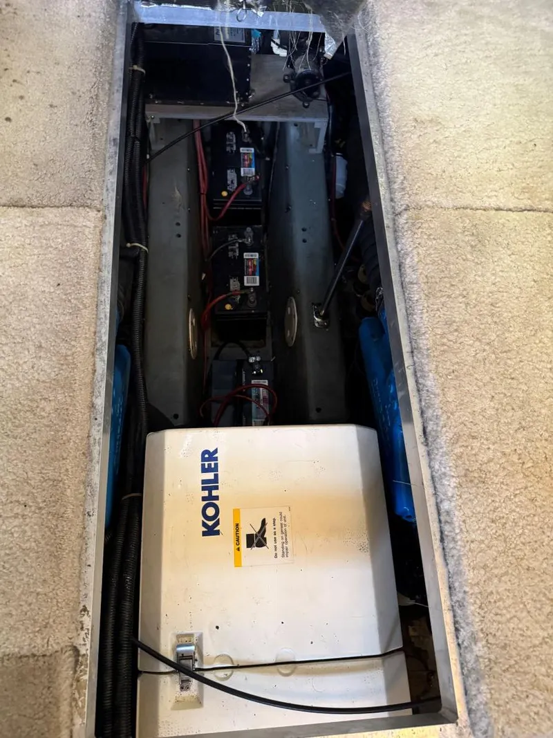 Slide: The Image of Engine compartment of 1994 Carver 350 Aft Cabin with Kohler generator and batteries. - 34